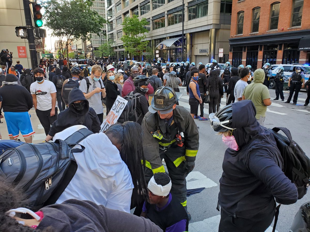 Street medics and CFD are operating on a women who had a bad gash on her head she was in and out of consciousness as people were working on her.  #Chicago  #GeorgeFloyd