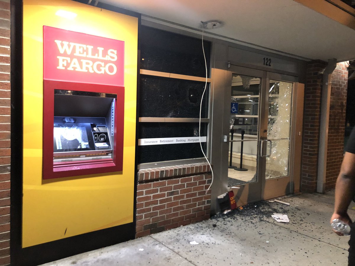 The Wells Fargo on E Grace has been destroyed. Surveillance camera taken. Front doors smashed in People are now breaking the drive thru windows