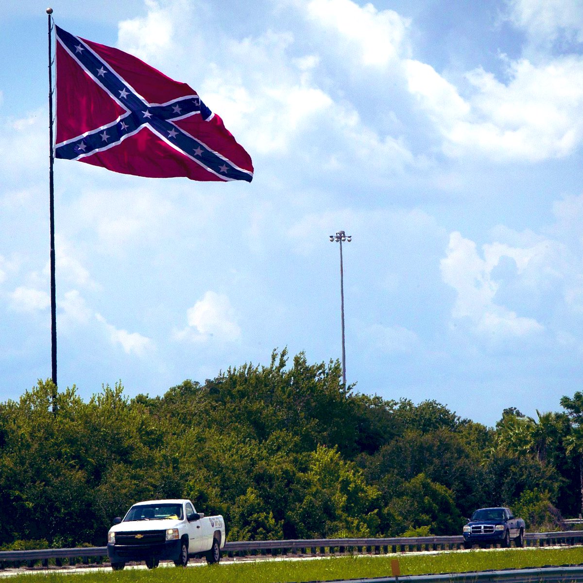 romelle's tweet photo. They burned down a gas station, currently plotting at the University Mall parking lot, But they really need to burn this flag down.   #TampaProtests https://t.co/OkCwSjFFl6