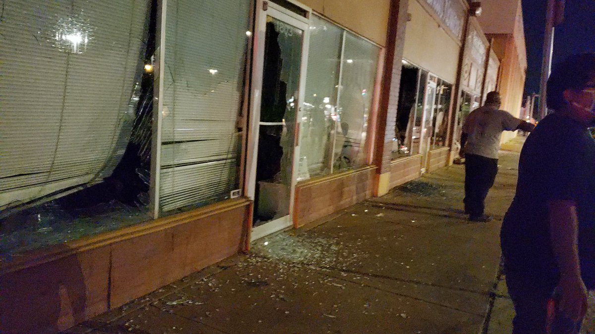 The crowd is headed to downtown. Some windows are being smashed in store fronts but others are trying to stop it.