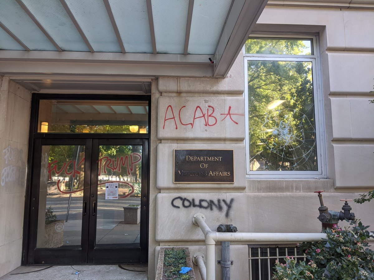 Someone graffitied over "veterans" on the sign at the VA headquarters, and wrote "Colony" beneath it.