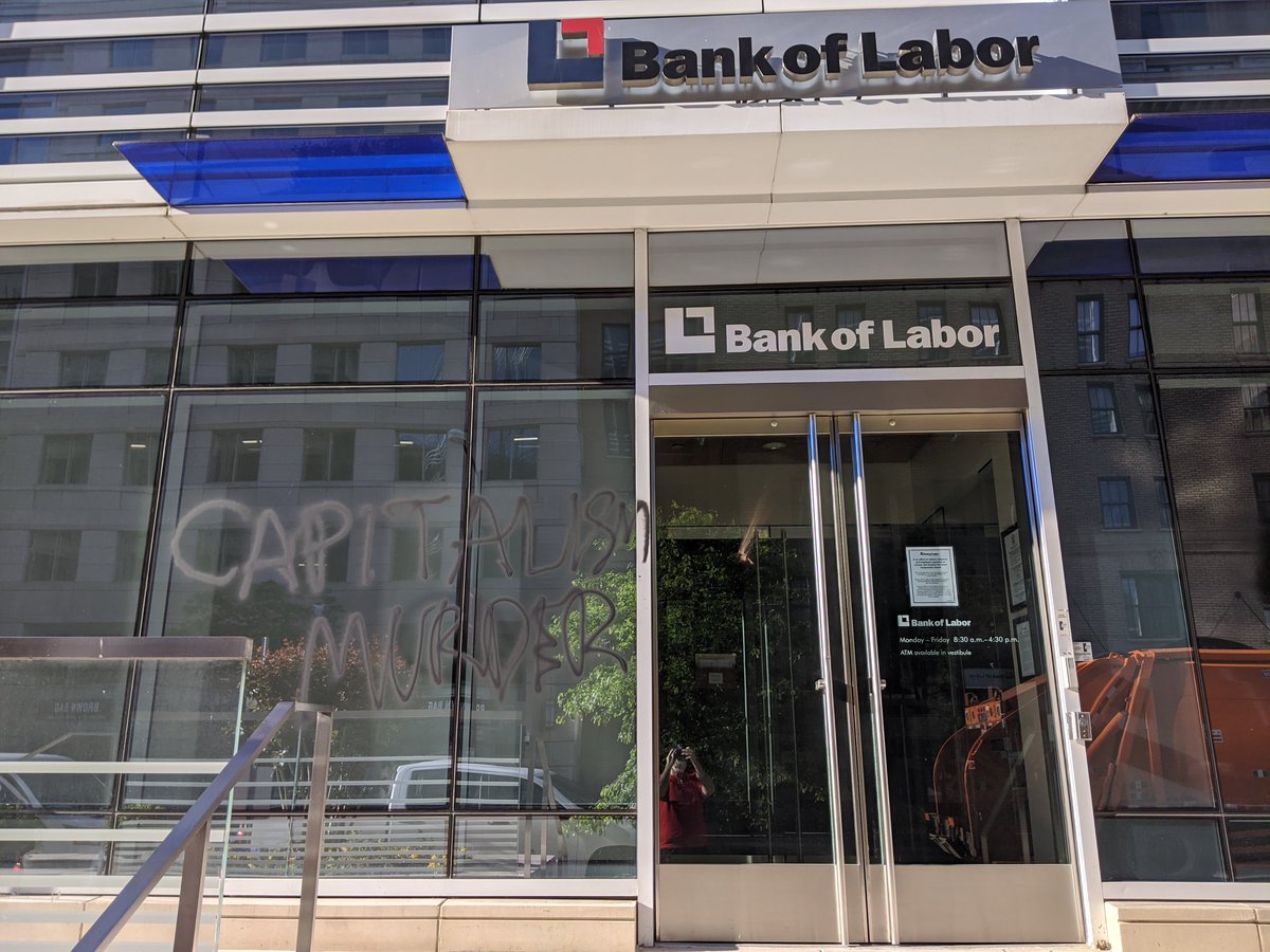 Smashed window and graffiti at Bank of Labor