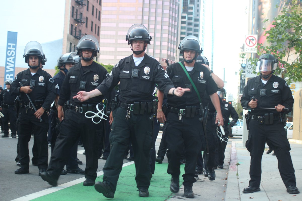 Story: We walked to DTLA, turned a corner onto Figueroa from Olympic, & got caught in a group of protesters running from cops. We were suddenly sandwiched from both sides by riot police. They made us sit. They advanced and I took this pic before arrest. I was the first arrested.