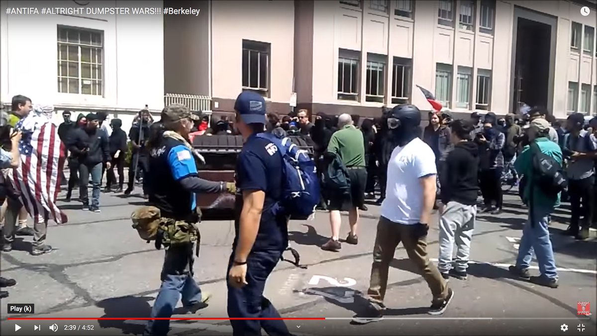 The bald man in the green shirt (center of frame) went right up to an Antifa leader and started filming him with a cellphone.