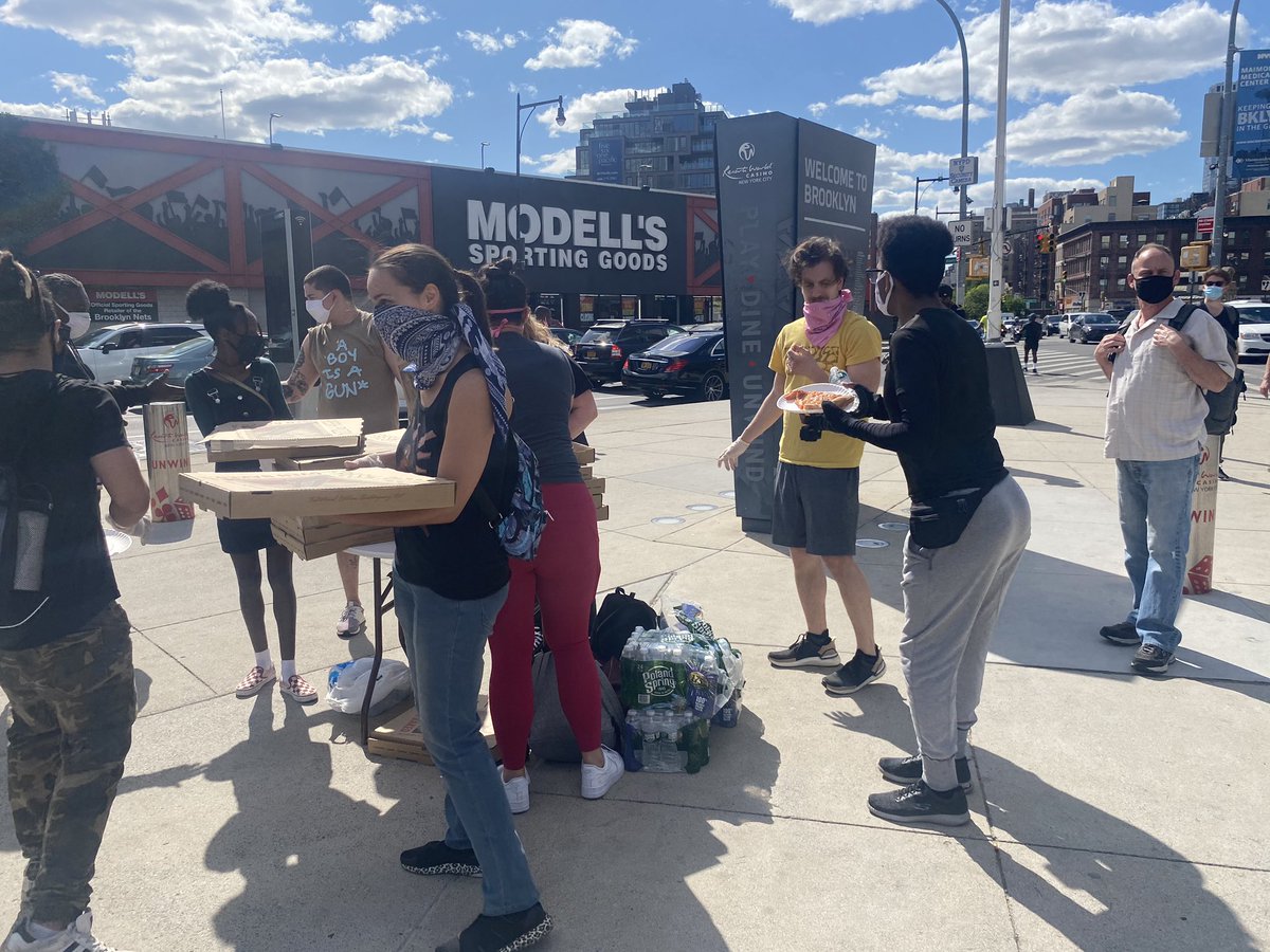 Some teens handing out pizza, granola bars, and water for protesters