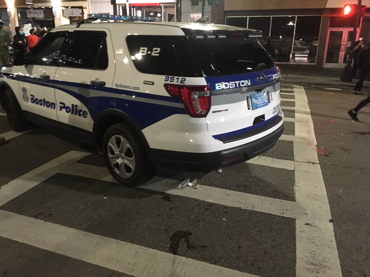 One patrol car left behind with a single cop had it's rear window broken in. Hopped up white boys started beating on it, pulled away by black protesters screaming at them not to touch it.  #BostonProtests