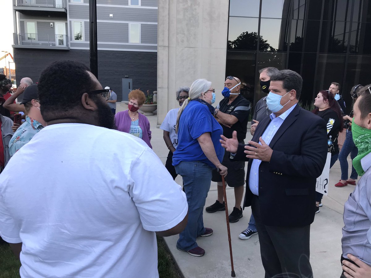 Outside city hall, Demonstrator asks Tony Roswarski, “What’s your position with the city?”“I’m the mayor.”