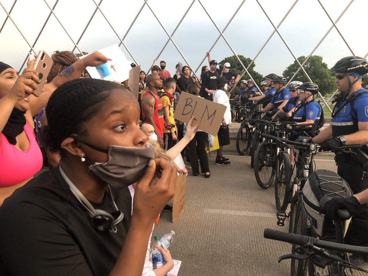 Recap. Protesters started downtown, marched peacefully for about 2 hours. Now, we’re on Trinity Bridge. officers blocking protesters from going to West 7th (lots of businesses there). Leaders tried to get ppl to leave, but many will not, say theyre peaceful.  #GeorgeFloydprotest