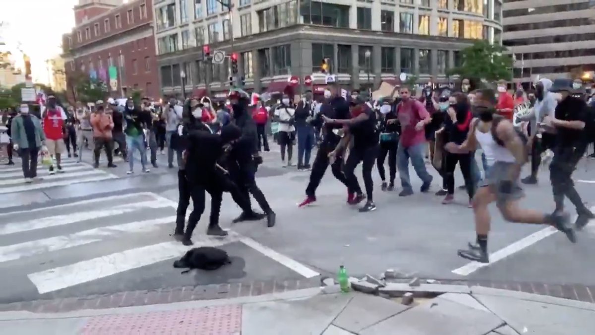 Muscle runs in from the right to take Antifa to the ground.