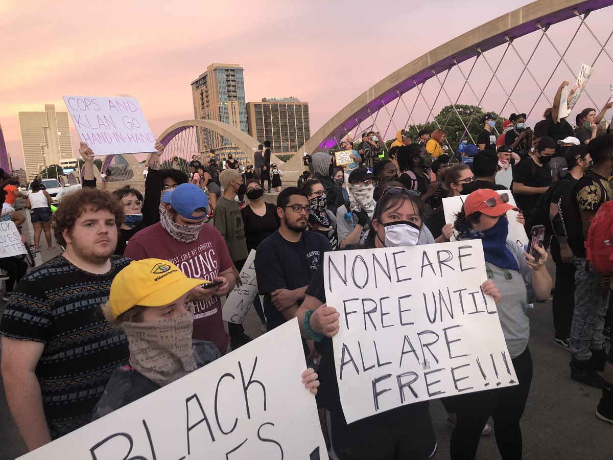 Sun begins to set in Fort Worth. Protesters still on the bridge. Been faced off with police for about 30 minutes I think.