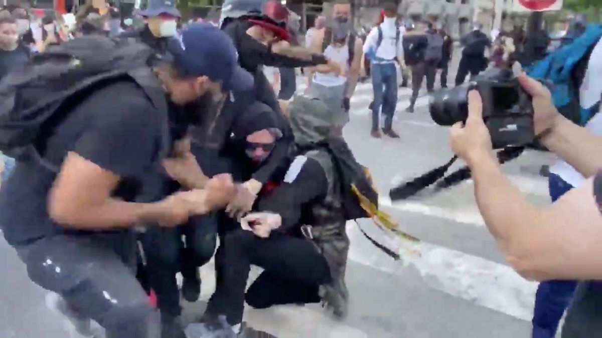 More muscle comes in from the left to take the rock hammer, and the team leader puts Antifa in a headlock.Look how CALM the team leader is.