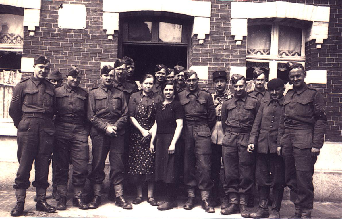 "Outside the Sgts. Mess (Estaminet), Monchy Cayeaux, May 1940" L to R: Sgt Summerfield; Frenchman; RSM Muggridge; QMS Goodman; Sgt Pudney; Sgt David; Proprietresses of pub; Pte. Brace; Unknown; Sgt Wenham; Sgt Major(RASC); French RSM; Sgt Rose; Sgt Roberts; Frenchman; Sgt Morgan.