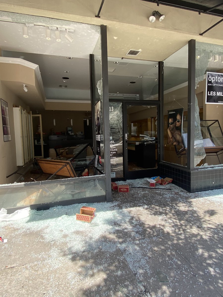 Vans and an eye glasses shop on 4th and broadway completely emptied and destroyed. Groups of people keep running in to grab more clothes and shoes. This started at the same time as the peaceful protest a few miles away. Completely different crowd