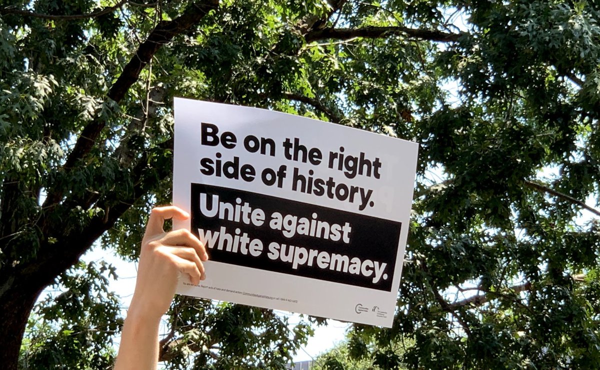 Photo of a protest sign that says "Be on the right side of history. Unite against white supremacy."