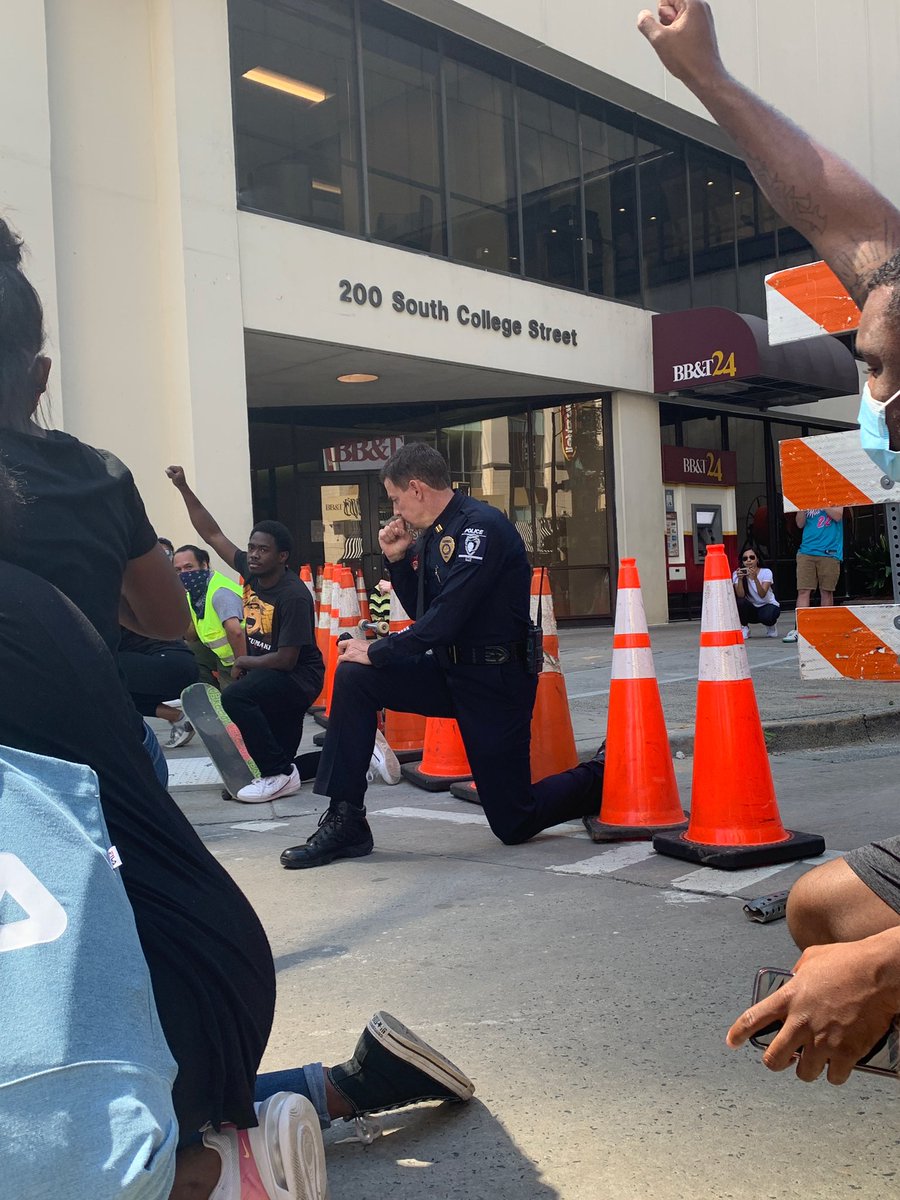 JordanHerald5's tweet photo. A Charlotte police officer taking a knee with everyone during a protest this afternoon. https://t.co/1y5xHqvWQ5