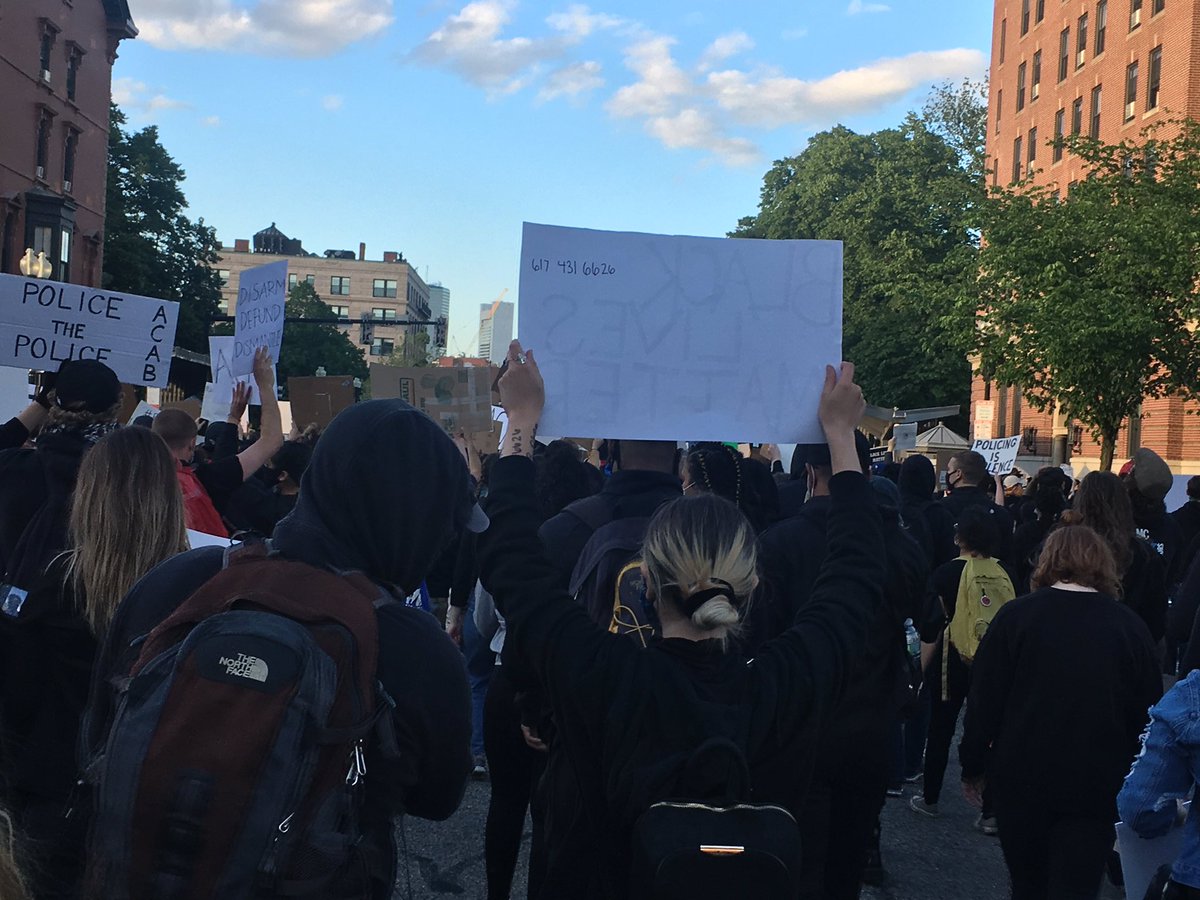 One protester has the number of legal support on the back of her sign, something that seems like a good idea.