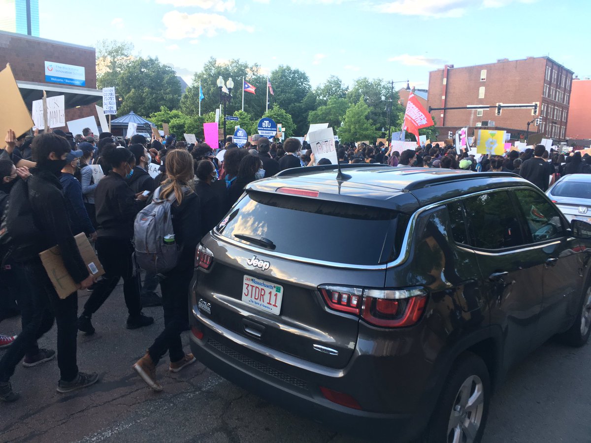 Members of Boston Teacher's Union carrying solidarity cards as they march with the crowd.  #bostonprotest