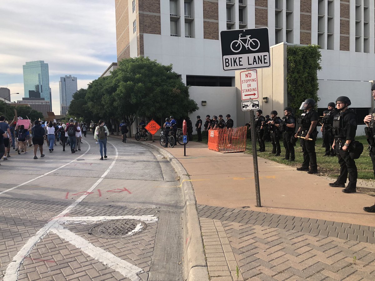 It’s mostly cops on bikes who are visible as we march. But when protesters got close to the interstate, officers in riot gear seemed to come out of nowhere to block the intersections. Protesters turned away on the planned route.