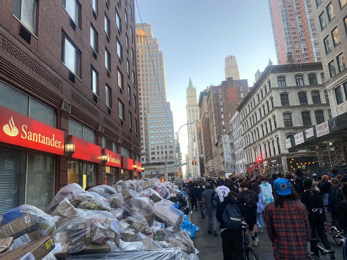 I commuted to the Manhattan protest — follow  @GwynneFitz &  @scottheins for Brooklyn uodates. Thousands of protesters now marching down Broadway (heaping pile of trash for scale)