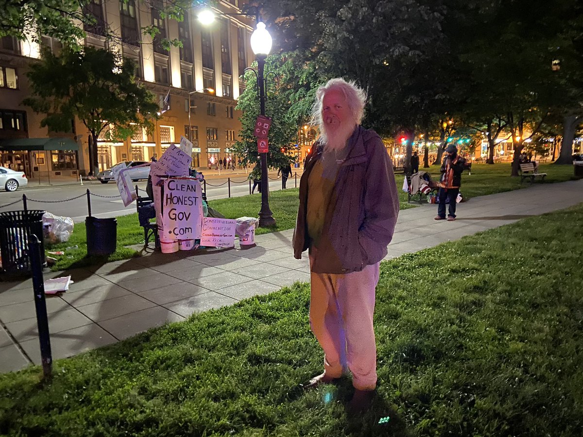 Protesters lit a trash can on fire feet away from the bench where Daniel, a 61 year old homeless man, sleeps in McPherson Square. He used water bottles people had given him to put it out. He sympathizes with the protesters, but has mixed feelings on tactics.