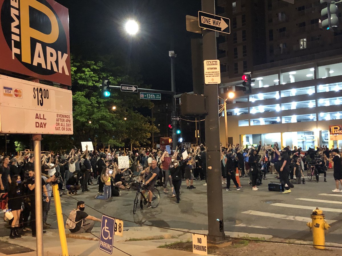 Crowd stops outside DPD HQ. Officers (these in the photo and many others) here waiting for them.