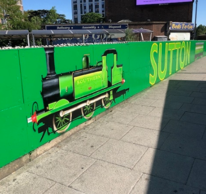 SuttonCouncil's tweet photo. Have you noticed the steam train artwork on the bridge area of Sutton Station recently? 🚉 🚂
Read how the Council's local committee for Sutton South, Cheam and Belmont and Network Rail made this happen!
#vintage #steamtrain #localcommittees #networkrail
https://t.co/SkuT3saaSJ https://t.co/WxKEAxBbNE