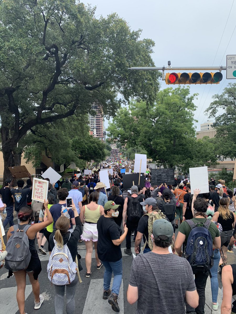 There was a loud bang near the front of the crowd and almost everyone started running backwards. After walking back maybe 5 feet, we began pushing forward again. Then, (it seems) the cops let us through, and we started marching again. (6/?)