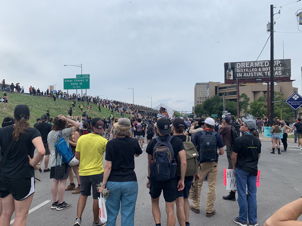 Eventually we made our way back to the capital, and started circling around to walk towards the police headquarters. This is also where I-35 has an overpass with the street below. About half of the group (including ya) went to the highway, blocking traffic (7/?)
