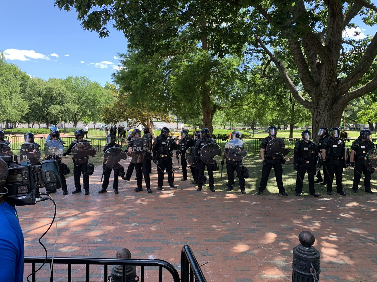 GarrettHaake's tweet photo. I am absolutely BAFFLED by US Park Police and Secret Service right now. Maybe two hundred protestors were sitting on H Street in front of Lafayette Park and police just formed a line in the park in full riot gear. Provocative and totally unnecessary. https://t.co/RN7pPE7Afi