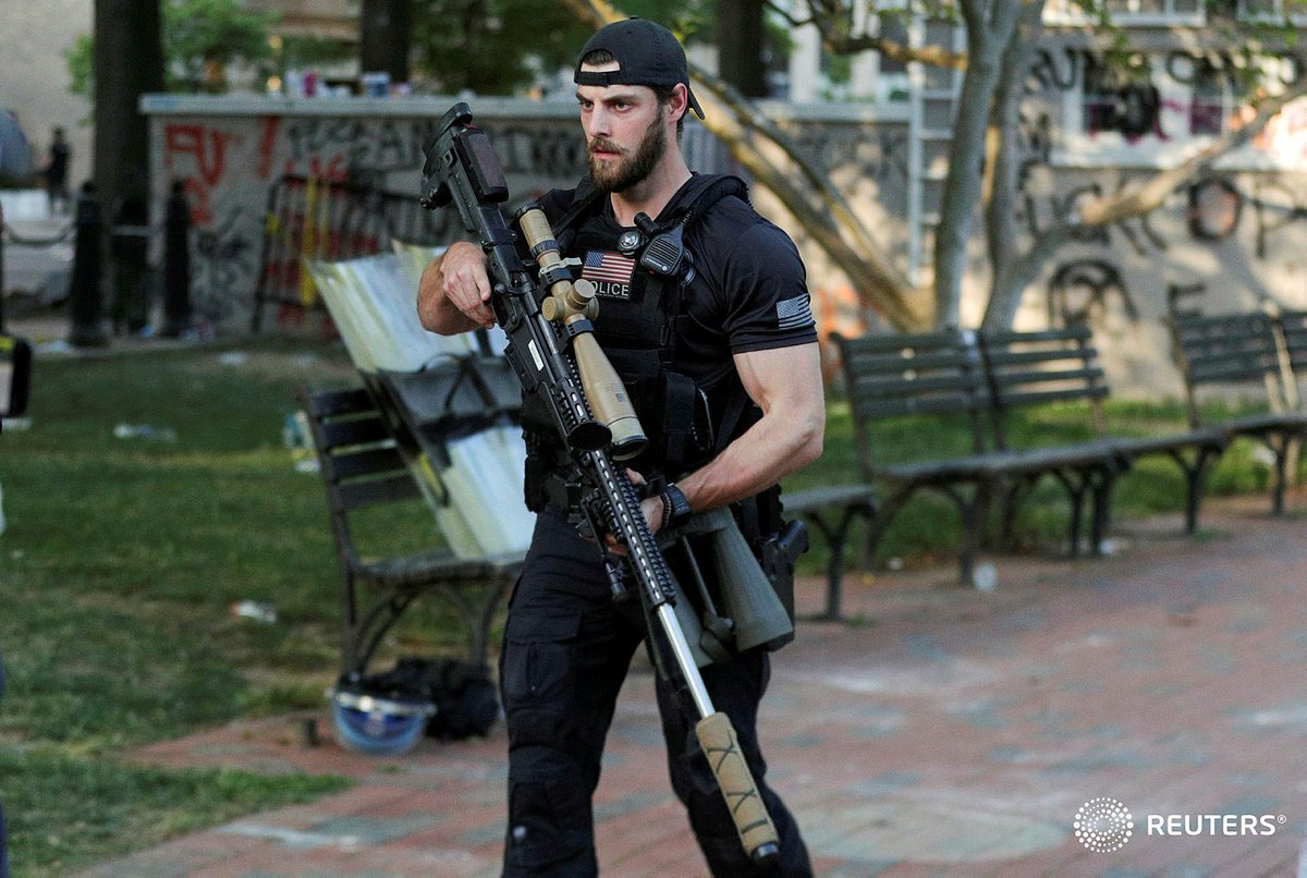 A U.S. Secret Service counter assault team member carries a sniper rifle through Lafayette Park as U.S. President Donald Trump holds a photo opportunity in front of St. John's Episcopal Church across from the White House. Photo by ⁦@tombrennerphoto⁩