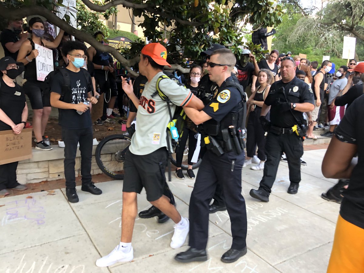 Huntsville police just pulled a young man out of courthouse crowd, cuffed and took him away. Crowd following.