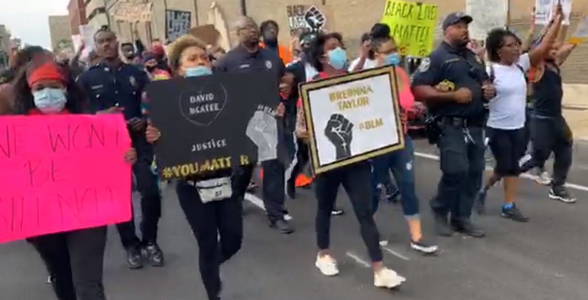 WDRBWAVE's tweet photo. Protesters and police link arms and march through downtown Louisville as demonstrators continue to demand justice for #BreonnaTaylor. Watch live here: https://t.co/UNsjO0m9e1 https://t.co/Rz8zLSbDkm