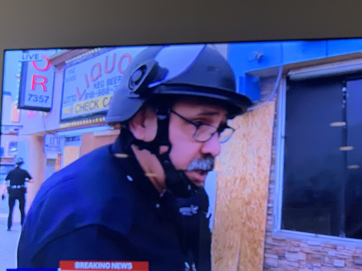 yogoldsmith's tweet photo. Now cops pull guns on store owners &amp; workers - who are African Americans &amp; were trying to stop the looters.

The Fox11 people are now explaining to cops - who refused to listen &amp; were just throwing the store personnel on the wall. https://t.co/96Krh1hHcO