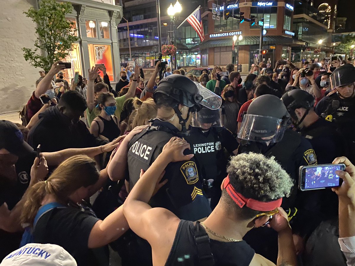 KylenMills's tweet photo. Protesters are now surrounding the officers and praying over them. “Jesus you are changing the way things are done here in Lexington.” @LEX18News #protest2020 https://t.co/5QPWybIemF