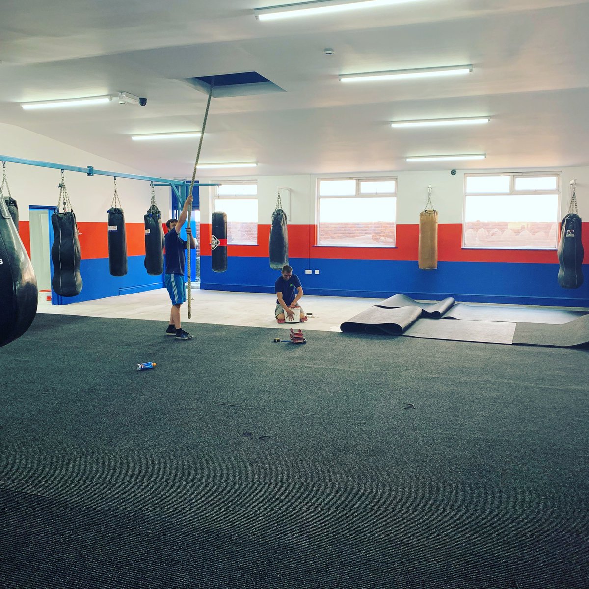 Boxing gym coming together in this hot weather.  Team work makes dream work 👊