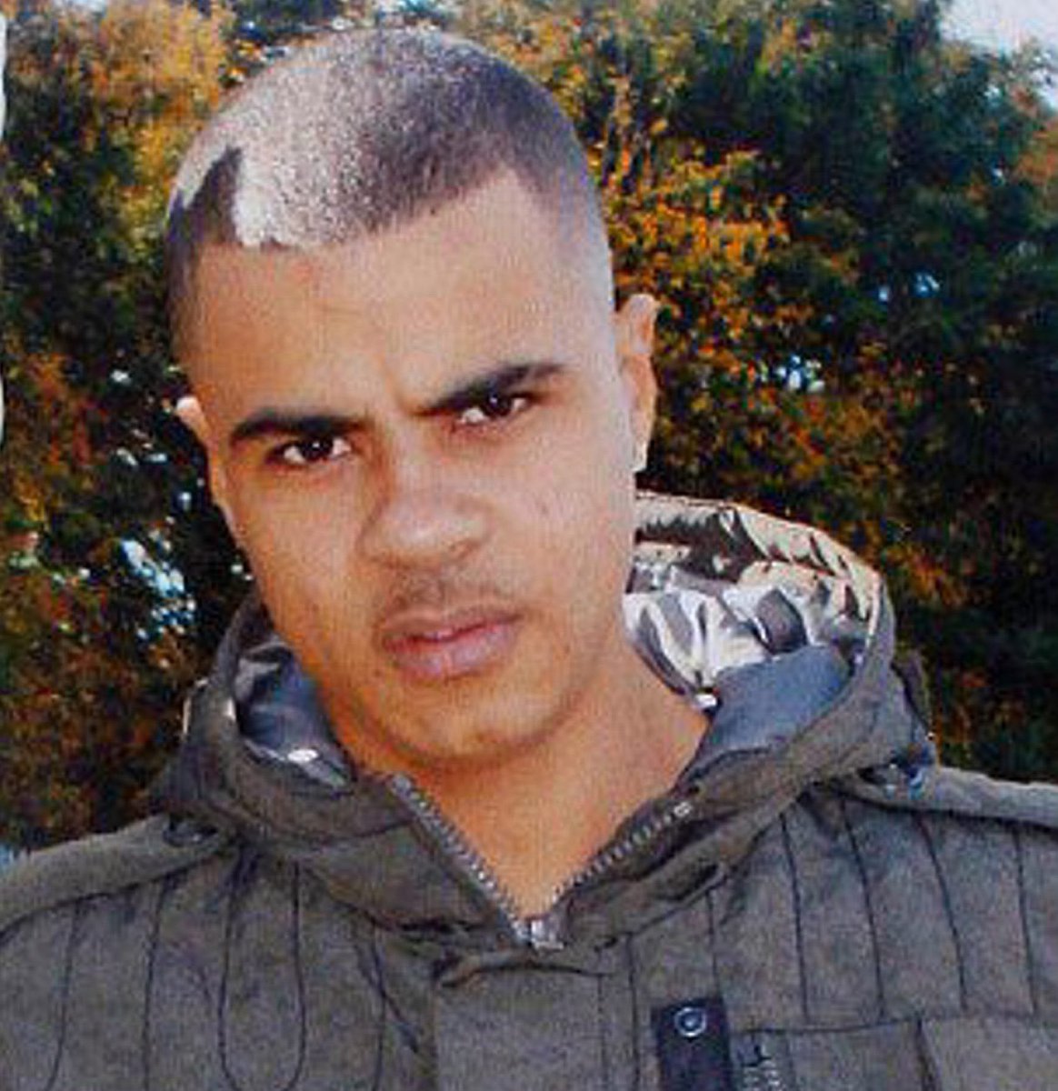 How Mark Duggan was portrayed by the media. The cropped image was use to show him as a thug and a criminal. He was holding a memorial of his late daughter.