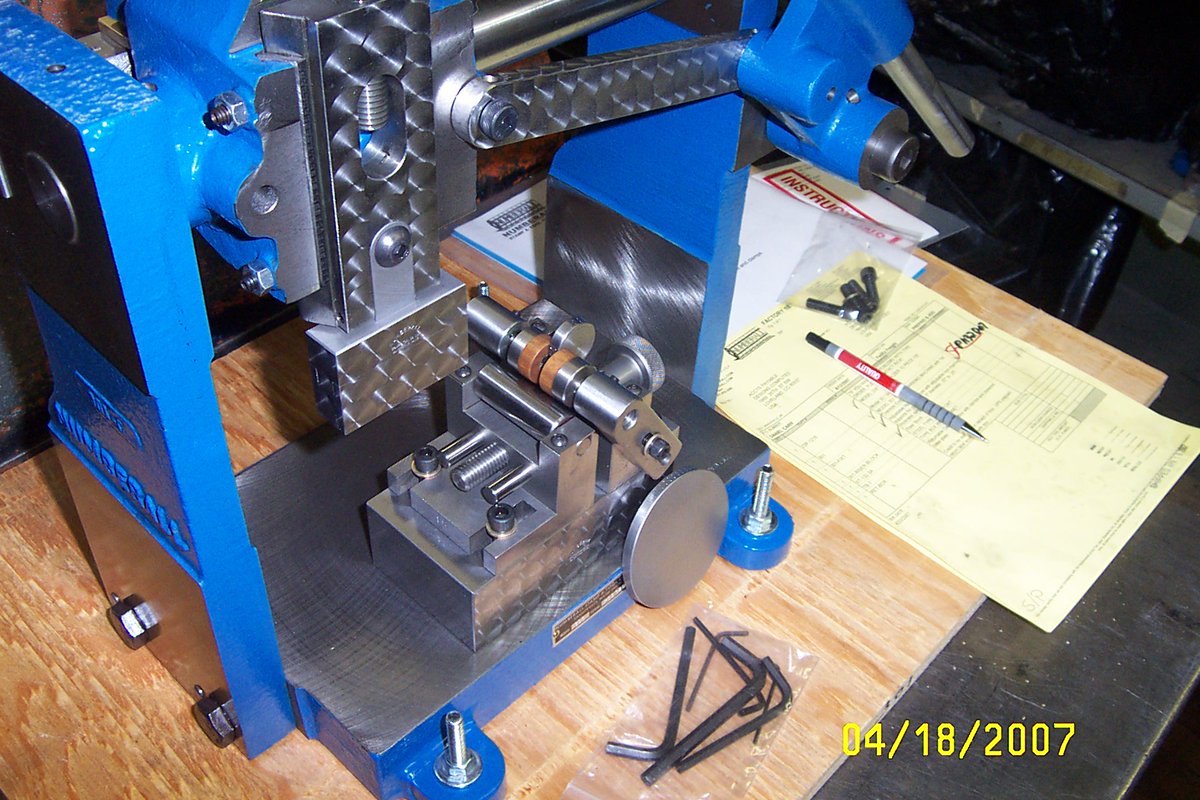 Numberall manufacturers identification equipment for  all industries.  Here's a custom setup for marking coins.  Using the Model 301 to mark around the edge of the coin.  Custom adjustable fixture to fit a range of coin sizes.  The round coin rotates as it is being marked.