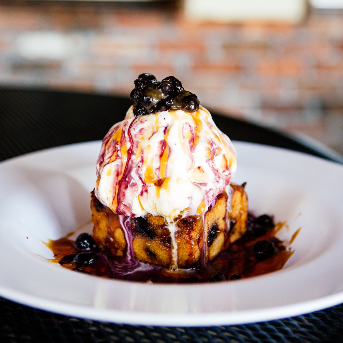 🤩 Blueberry Bread Pudding 🤩 
Macerated blueberries stacked in-between custard bread and finished with bourbon caramel sauce and more blueberries. À la mode. Perfect finish.
#hoptinger