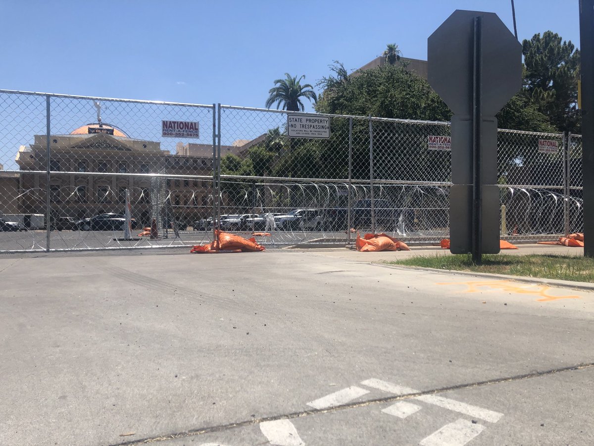 dennis_welch's tweet image. The state Capitol giving off some real prison vibes today with the orange sandbags and razor wire.