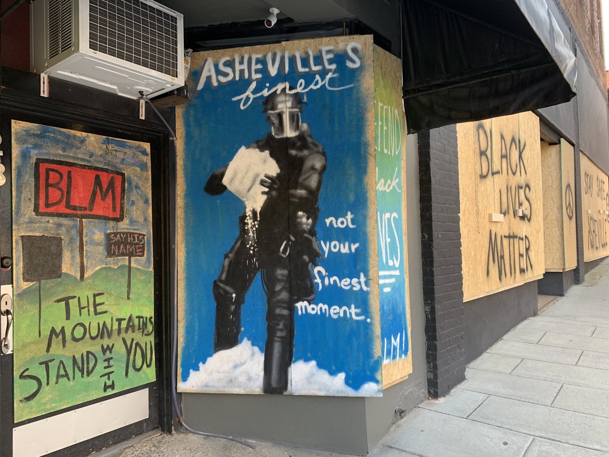 Ashevegas's tweet photo. Downtown #Asheville mural art depicting a scene from the #Asheville Police Department’s attack Tuesday night on a medic station set up to aid anyone injured in protests. #avlnews https://t.co/nY4CS8UyxY