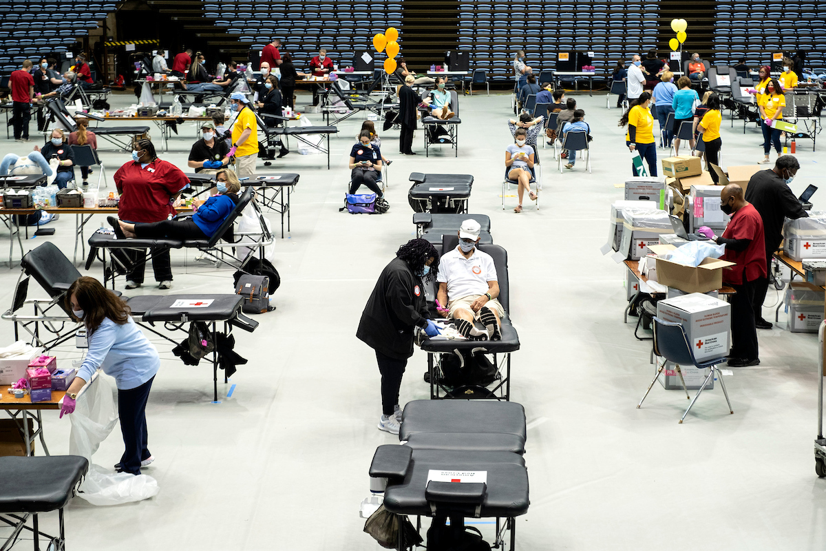 Wide shot of people donating blood at the drive 