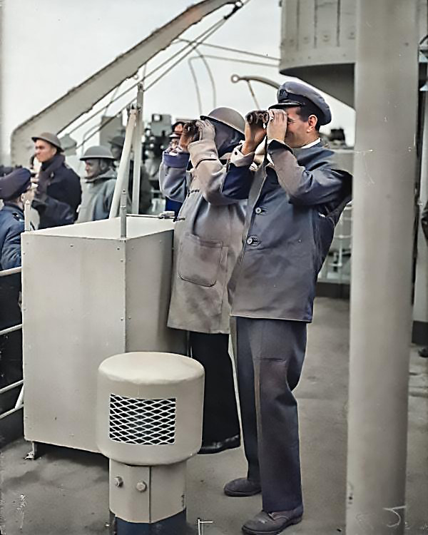 Captain Sir Harold Campbell RN and Commander A Kimmins RN watch the progress of the landing of 50th Division from HMS Bulolo, headquarters ship of Assault Force G, 6 June 1944.