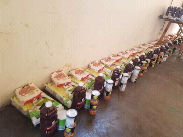 GautengTogether's tweet photo. Thula and Thato help with the 'door to door' visits as well as packing and distribution of the food parcels. Sandra praises the speed and efficiency with which the #Sobae couple transform a room full of newly donated food, in a packaged row ready for collection.#socialsolidarity https://t.co/yTuozhk9su