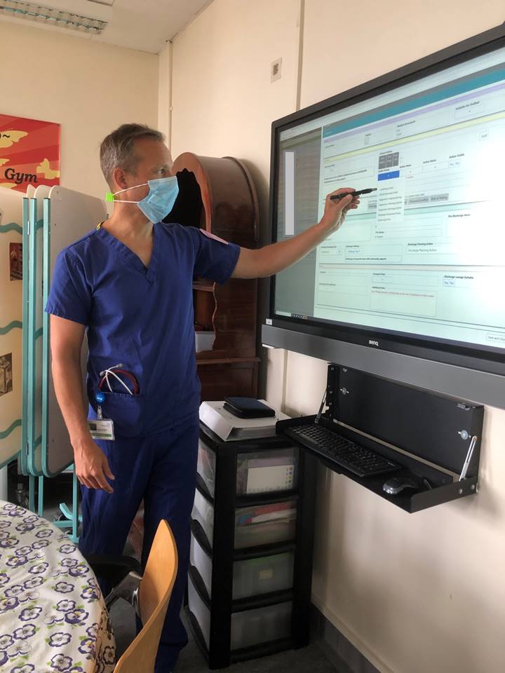 Consultant James Croft-Baker leading the F1 Board Round  using the eWhiteboard. "I think this is fantastic, a one point of communication for all teams on the wards &amp; reducing duplication of work. This is a great step forward for planning patient care &amp; flow"