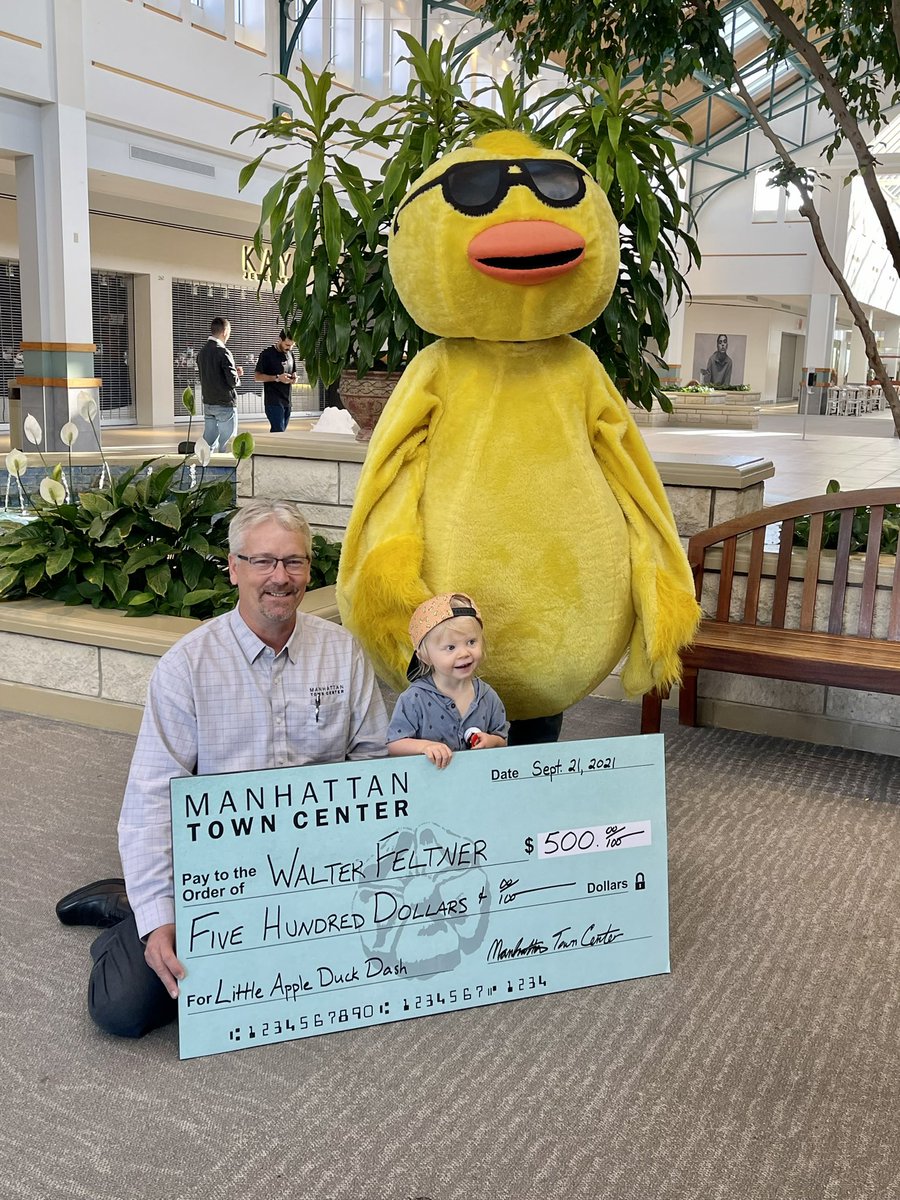 A BIG congratulations to 2-year-old Walter, who won a $500 #MHKmall gift card from the #bgclubmanhattan Duck Dash! Walter's grandma purchased a duck for him.  Pictured is Manhattan Town Center General Manager Brad Simonsson presenting Walter with his prize (along with Ducky).