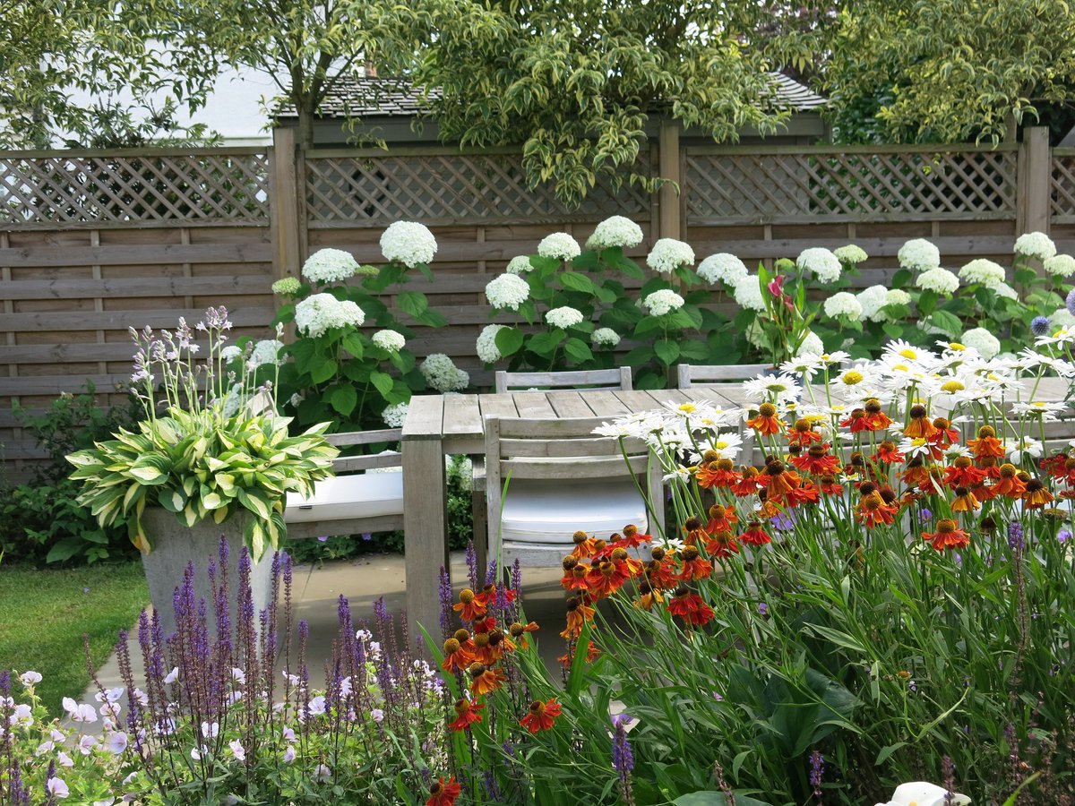 More #inspiration for your #garden from one of our <a href="/GreenardenD/">GreenArden design</a> #gardendesigns: frame a seating area with Hydrangea Annabelle and planting with herbaceous perennials such as heleniums, Chasta daisies and Salvias. 
#gardendesigners #plantingdesign #flowers #plants #gardenstyle