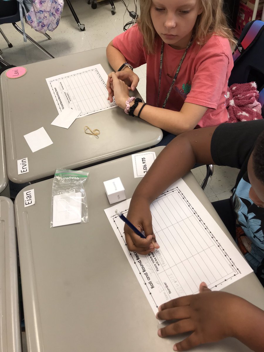 KimGlover9's tweet photo. Partners practicing rounding. Choose a card and roll the die to which place to round to. Love seeing peers helping one another. @TweetDCS_OES #teamdcs https://t.co/UhwG9qE3Yf