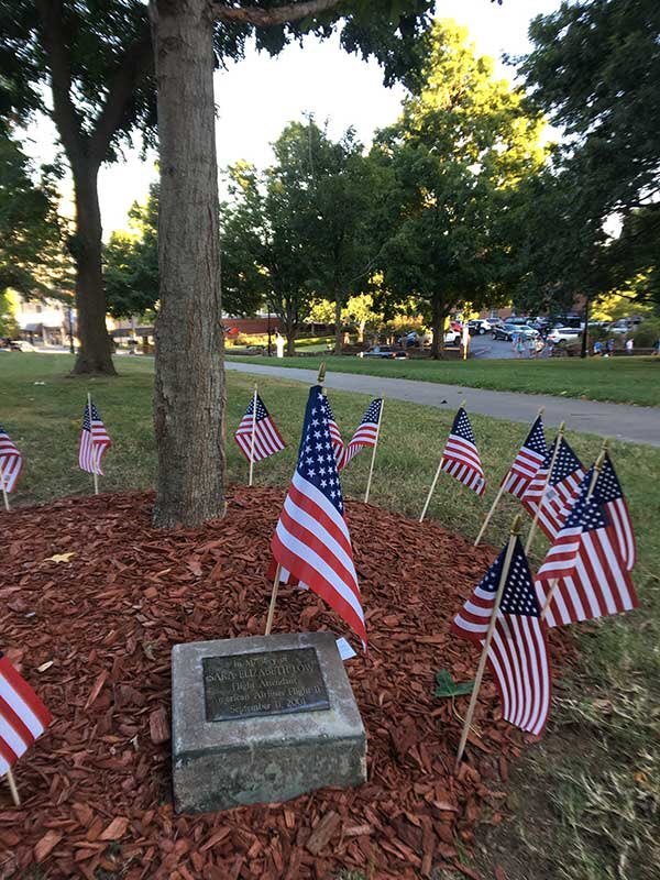 UArkansas's tweet photo. Today we remember #UARK alumna Sara Low and the other 2,752 people who lost their lives 20 years ago in the terrorist attacks on September 11. We will never forget. 🇺🇸

Photo: 
American flags encircle a maple tree planted as a memorial to alumna Sara Low. https://t.co/S1R8drKA7H