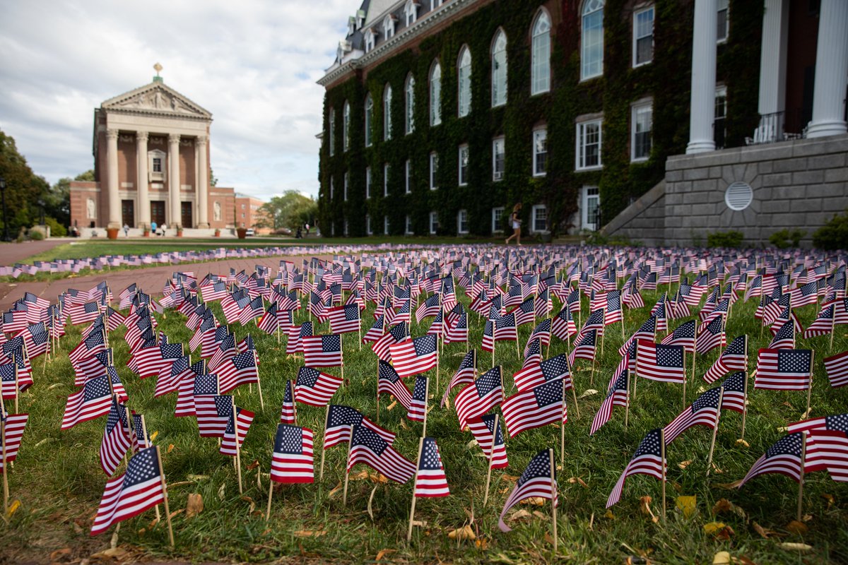 holy_cross's tweet photo. "Each of these 2,977 flags signifies someone who didn't return home on 9/11. This year marks the 20th anniversary of the attacks, and it was incredibly moving to be able to not only set up the memorial on the Holy Cross campus but to attract volunteers..." (1/2) #NeverForget https://t.co/SNnbjY66qU