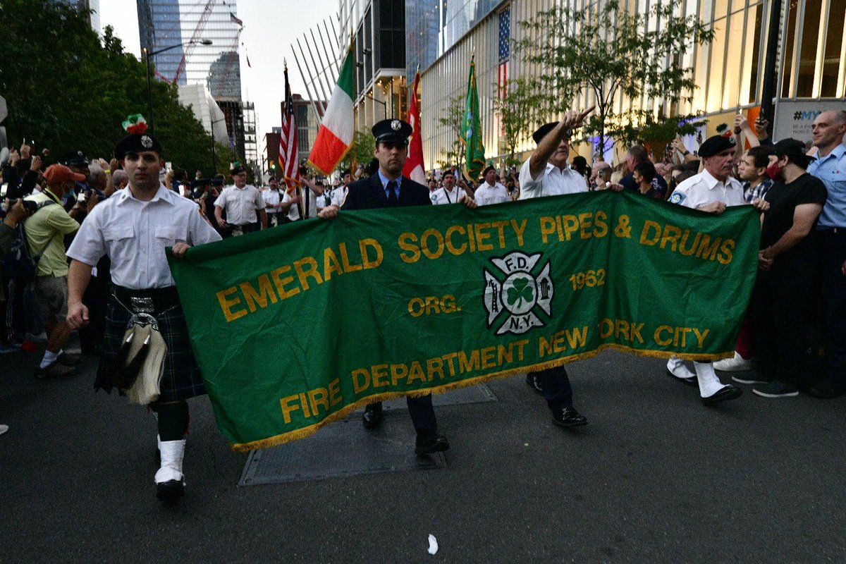 FDNY's tweet image. New Yorkers and visitors to our great city gather as the FDNY Emerald Society Pipes and Drums band honors those who made the Supreme Sacrifice 20 years ago at their annual sunset tribute at FDNY #Engine10 and #Ladder10 #NeverForget